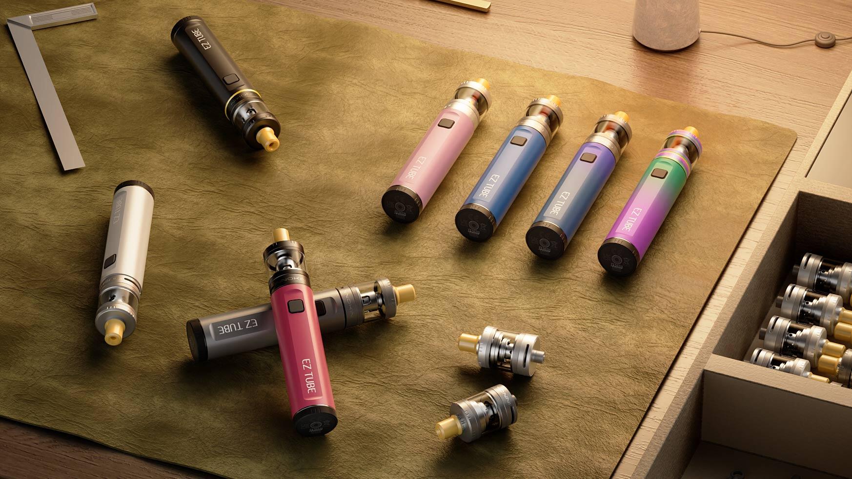 Eine Sammlung moderner, farbenfroher Vape Pens und abnehmbarer Coils, die auf einer grünen Lederoberfläche ausgebreitet sind, veranschaulicht häufige Fehlerbehebungsszenarien - z. B. dass ein Vape Pen nach dem Aufladen nicht mehr funktioniert - inmitten eines gut organisierten Arbeitsbereichs.
