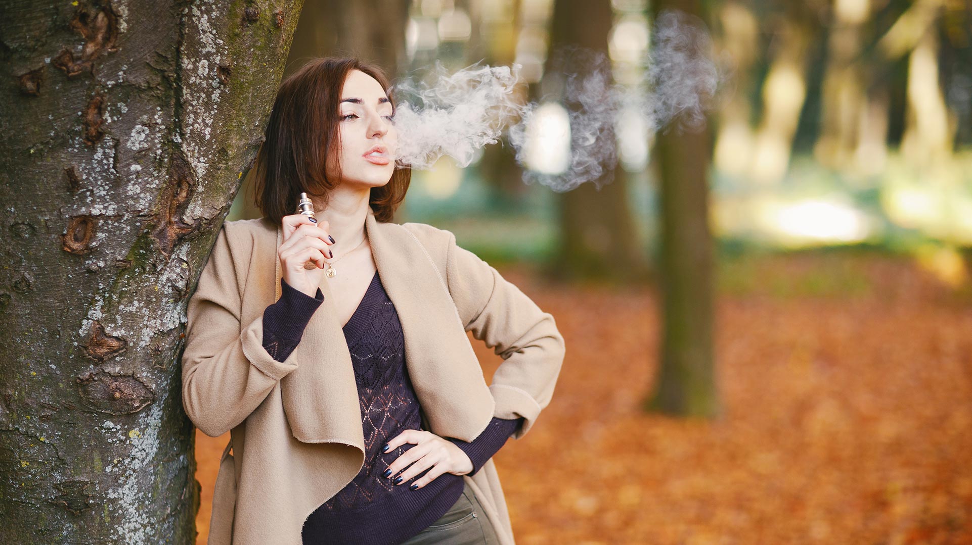 Eine Person dampft in einem Wald, was die Verwendung von pflanzlichem Glycerin und Propylenglykol in E-Liquids veranschaulicht.