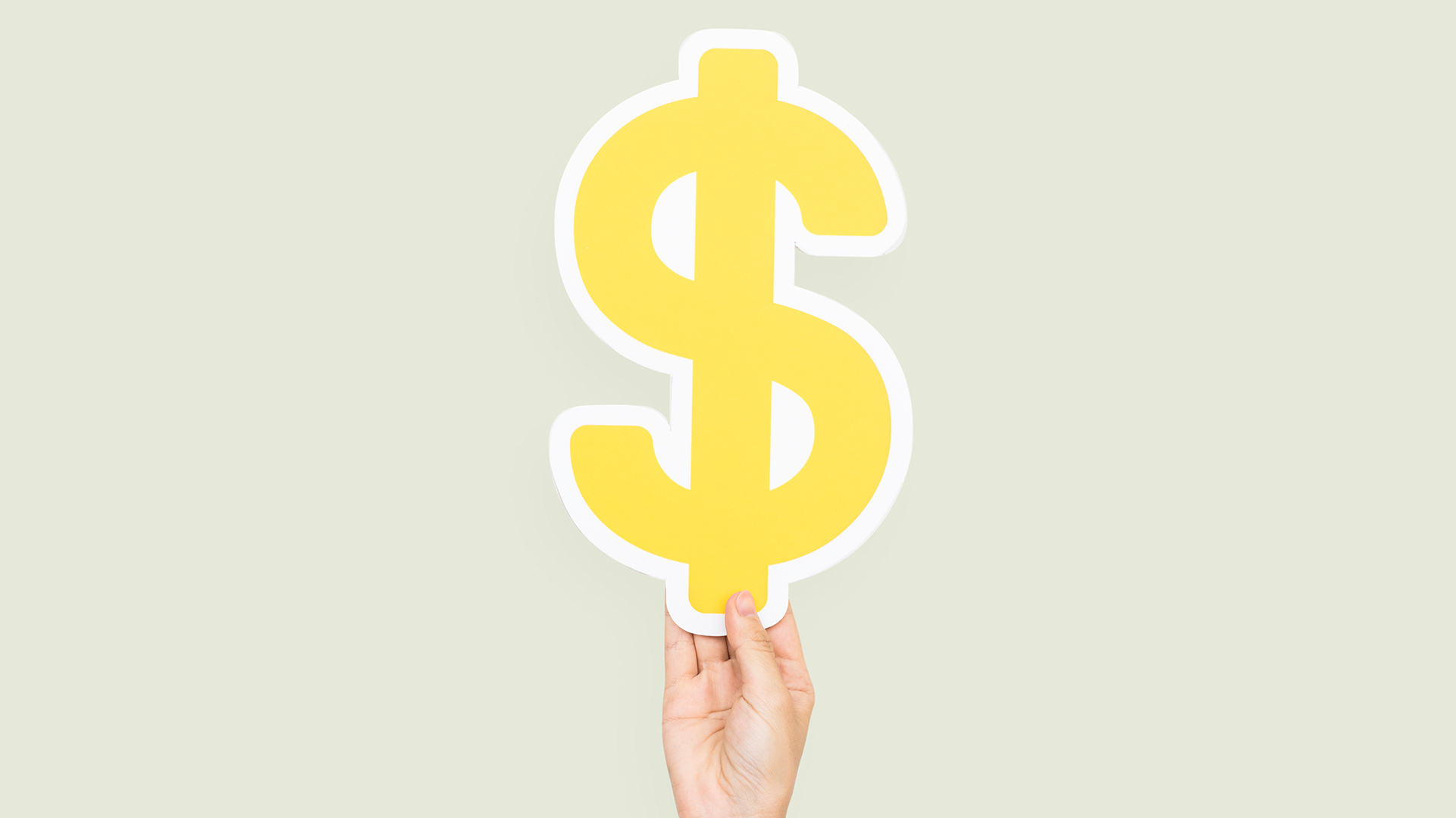 Die Hand hält ein Dollarzeichen, das die höheren Kosten beim Kauf von Vapes an Tankstellen im Vergleich zu Vape-Shops symbolisiert.